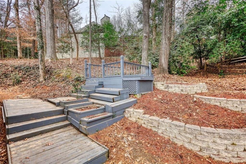 4205 Aberdeen Pass Roswell, GA 30075 - Photo 44 of 53 a view of a yard with plants and wooden fence