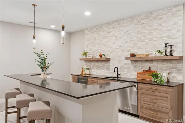 a kitchen with stainless steel appliances granite countertop kitchen island sink stove and cabinets