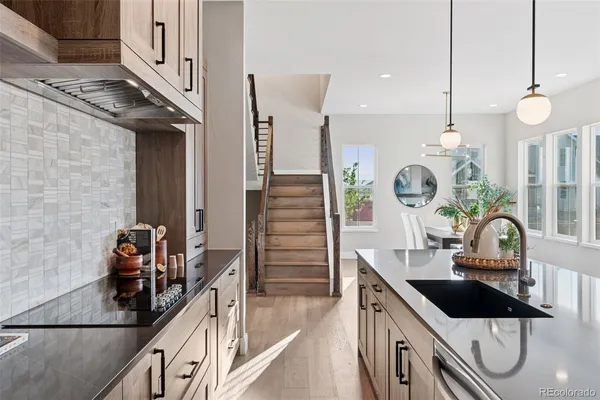 a kitchen with a sink a stove and cabinets