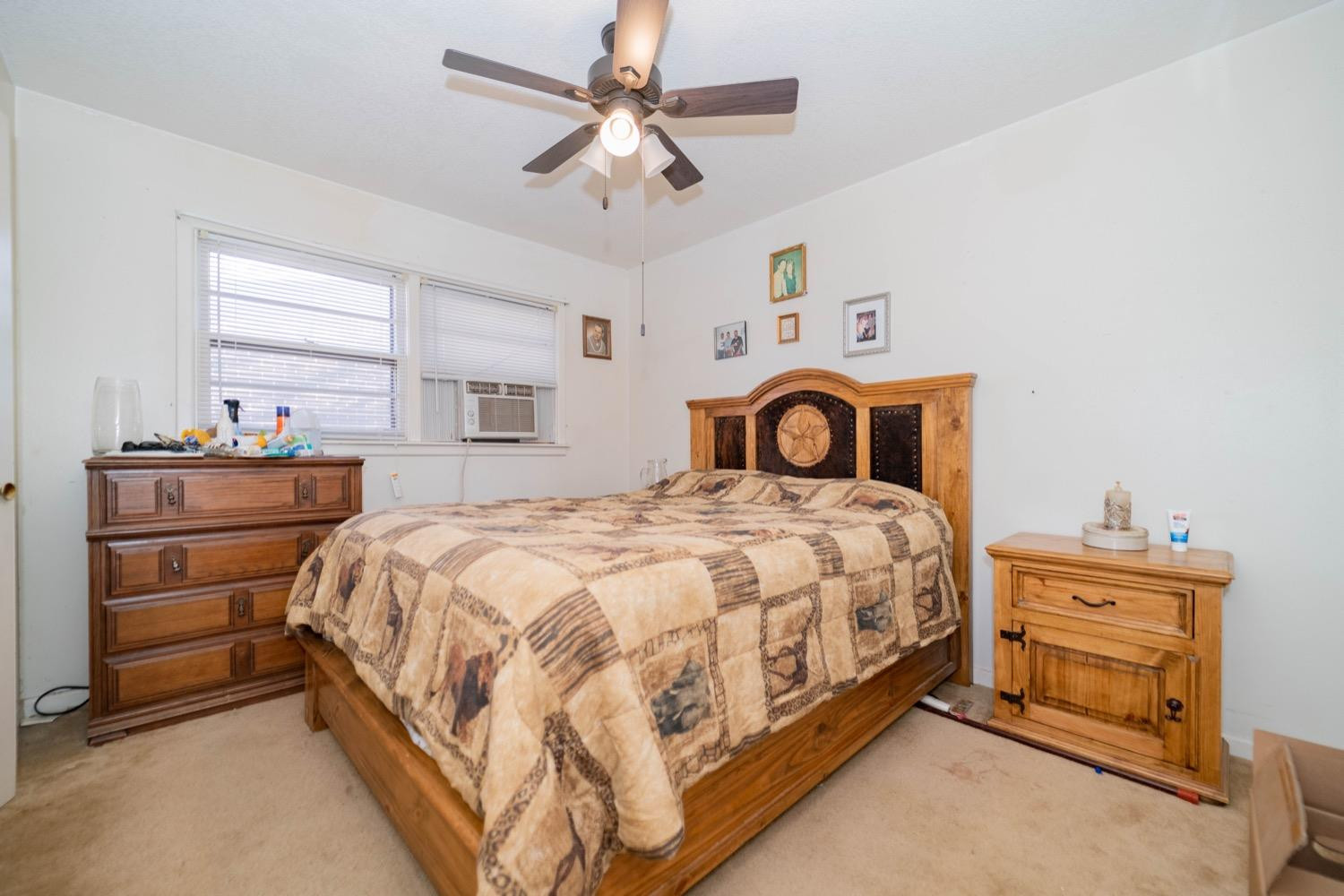 4811 43rd Street Lubbock, TX 79414 - Photo 13 of 20 a bedroom with a bed and ceiling fan