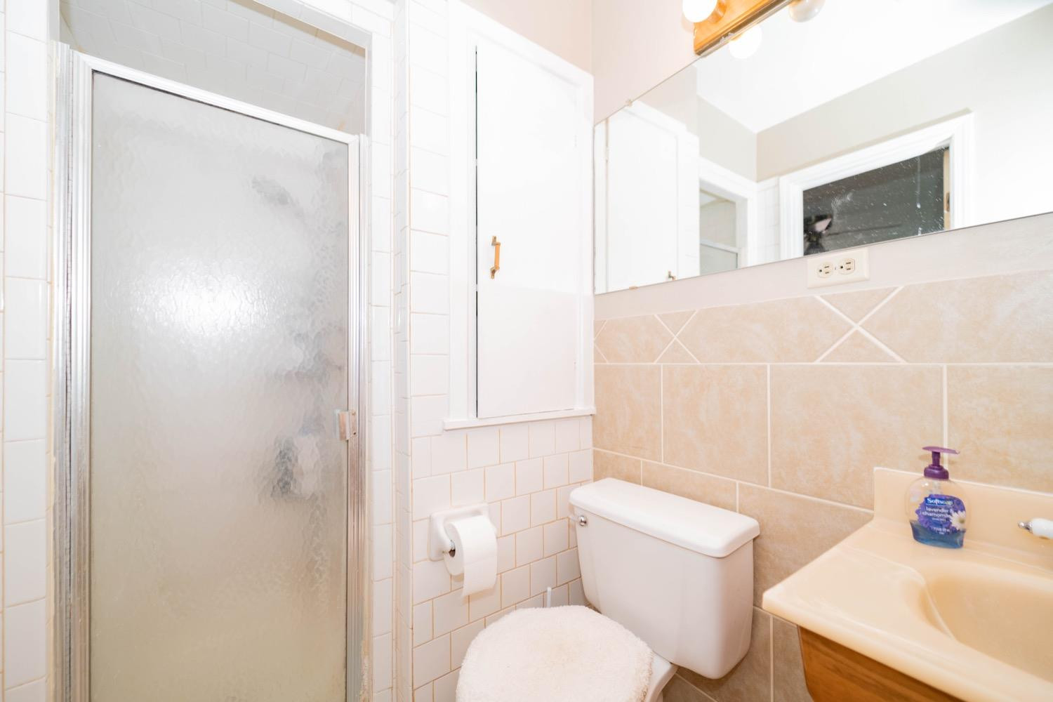 4811 43rd Street Lubbock, TX 79414 - Photo 14 of 20 a bathroom with a sink toilet and shower