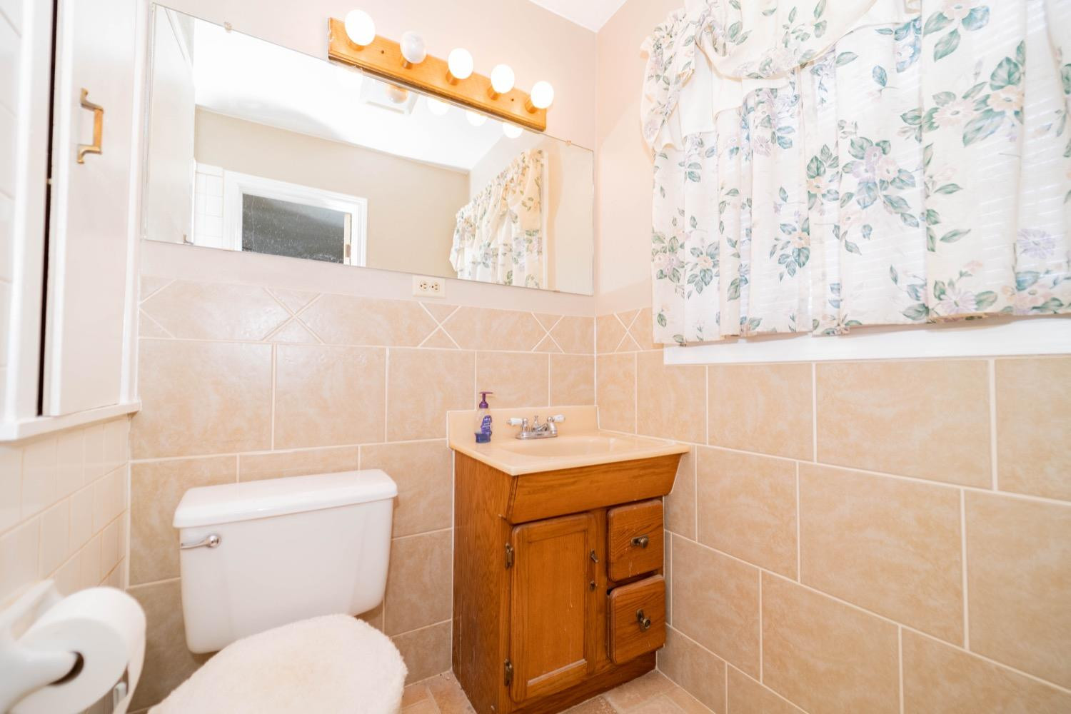 4811 43rd Street Lubbock, TX 79414 - Photo 15 of 20 a bathroom with a sink toilet and mirror