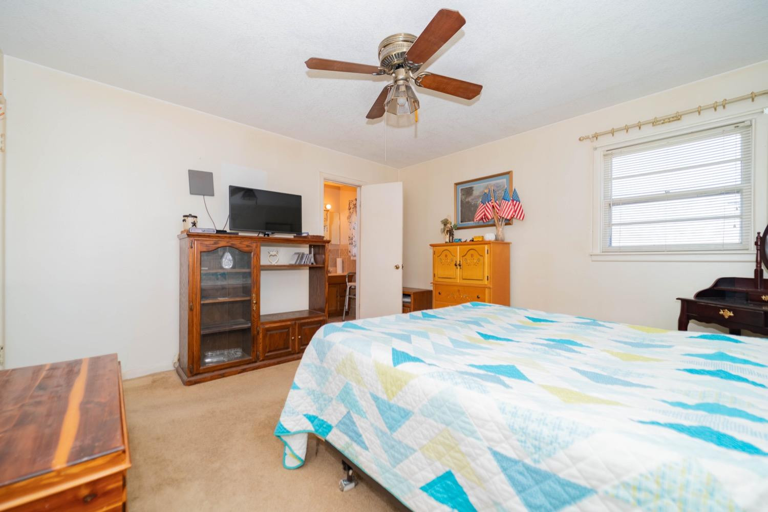 4811 43rd Street Lubbock, TX 79414 - Photo 16 of 20 a bedroom with a bed and a television