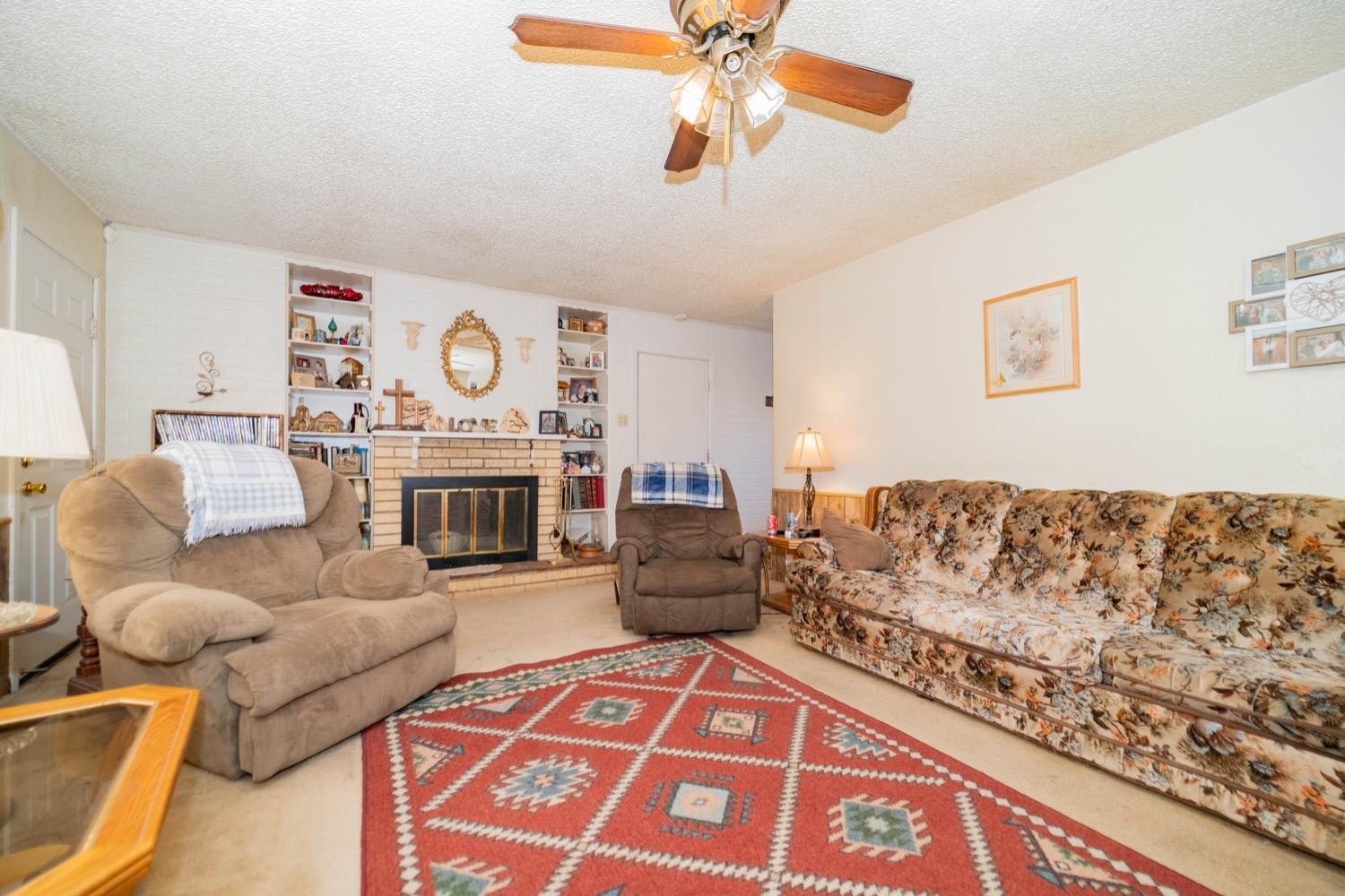 4811 43rd Street Lubbock, TX 79414 - Photo 3 of 20 a living room with furniture and a fireplace