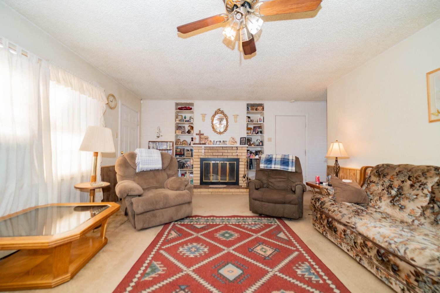 4811 43rd Street Lubbock, TX 79414 - Photo 4 of 20 a living room with furniture and a fireplace