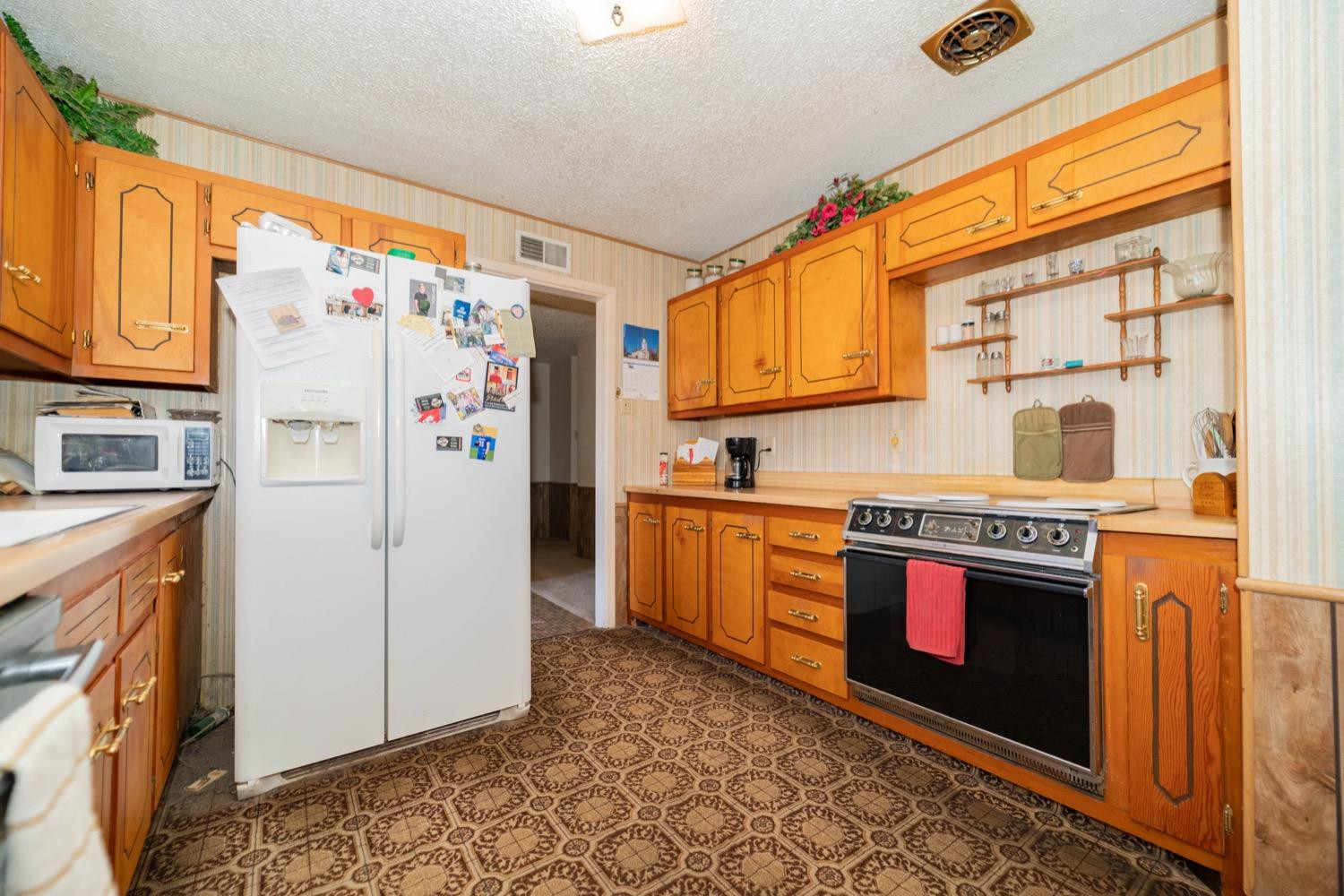 4811 43rd Street Lubbock, TX 79414 - Photo 6 of 20 a kitchen with stainless steel appliances granite countertop a refrigerator and a stove top oven