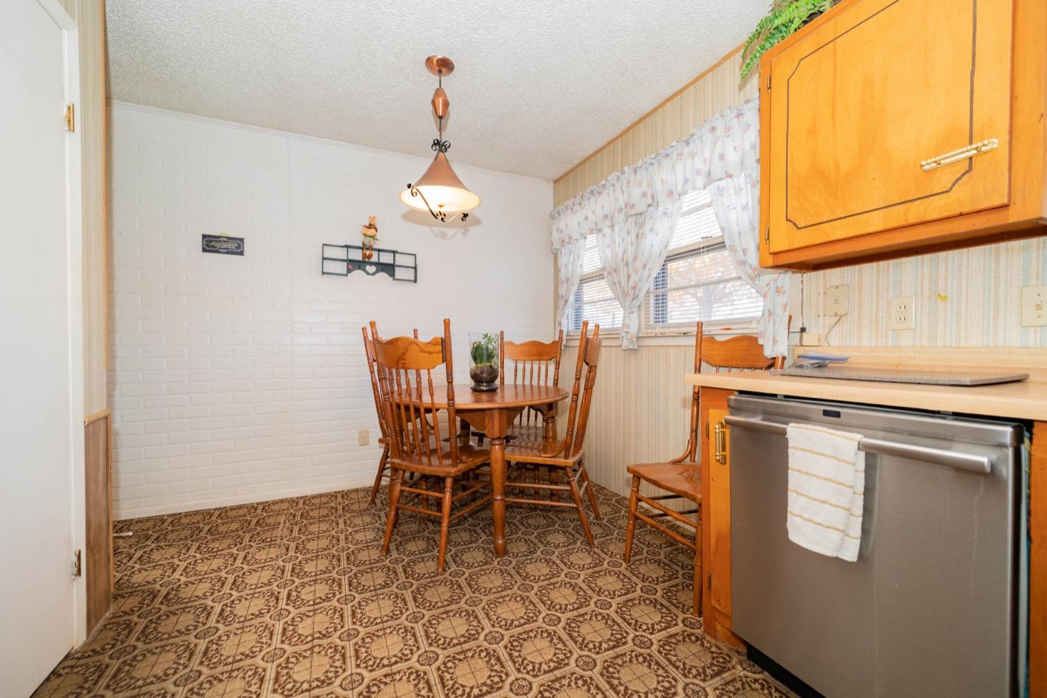 4811 43rd Street Lubbock, TX 79414 - Photo 9 of 20 a dining room with stainless steel appliances a window and kitchen view