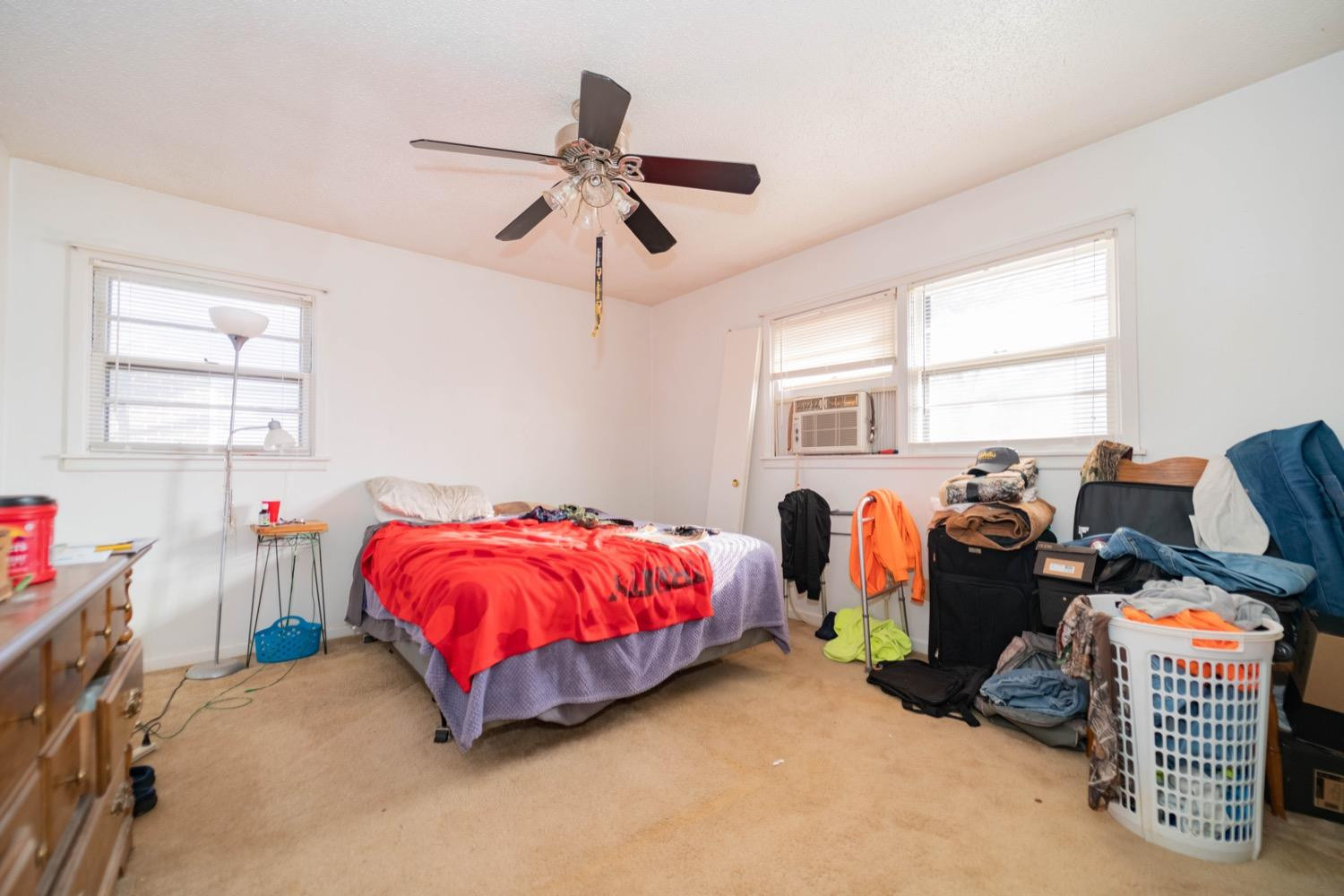 4811 43rd Street Lubbock, TX 79414 - Photo 10 of 20 a bed room with a bed and a chandelier