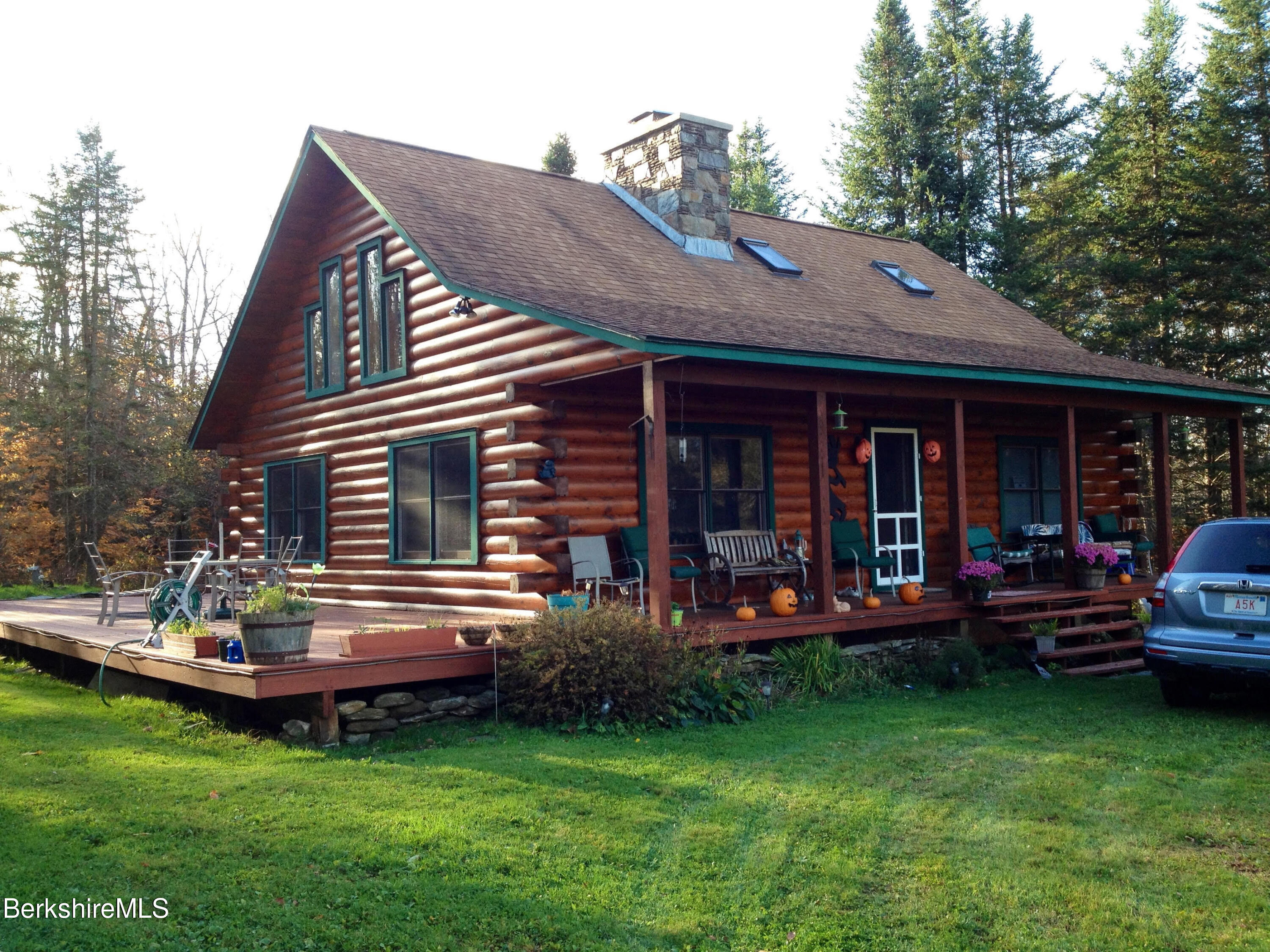 565 New State Road Savoy, MA 01256 - Photo 1 of 24 a view of a house with a yard and sitting area