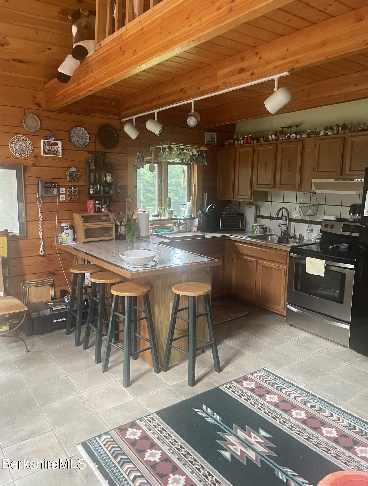 565 New State Road Savoy, MA 01256 - Photo 2 of 24 a kitchen with lots of counter top space and stainless steel appliances