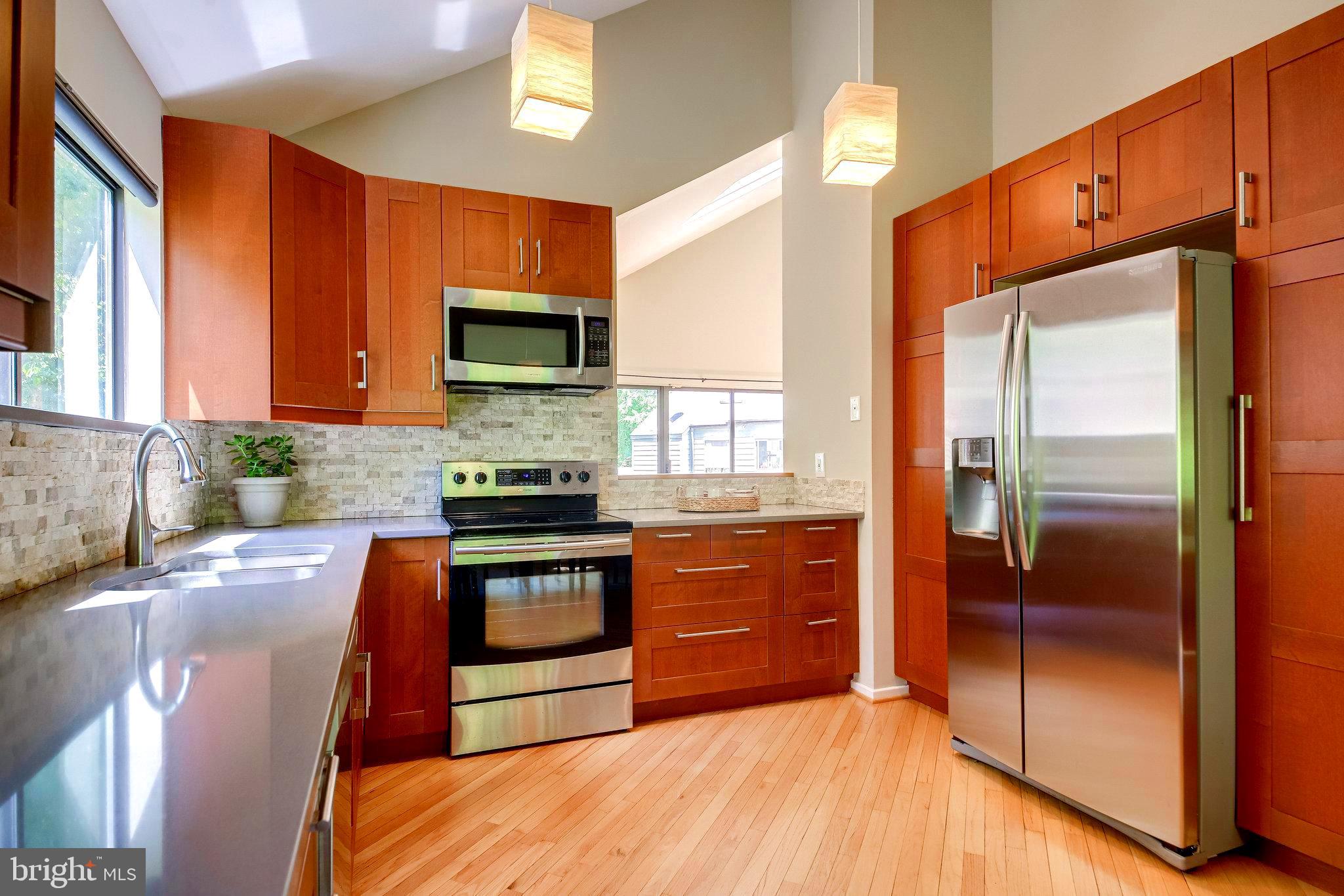 1656 Cedar Hollow Way Reston, VA 20194 - Photo 6 of 36 Gleaming quartz counters, cut out into the LR