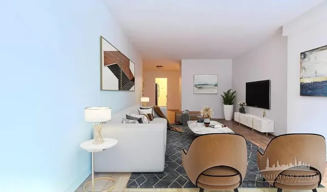 a room with furniture a flat screen tv and a lamp