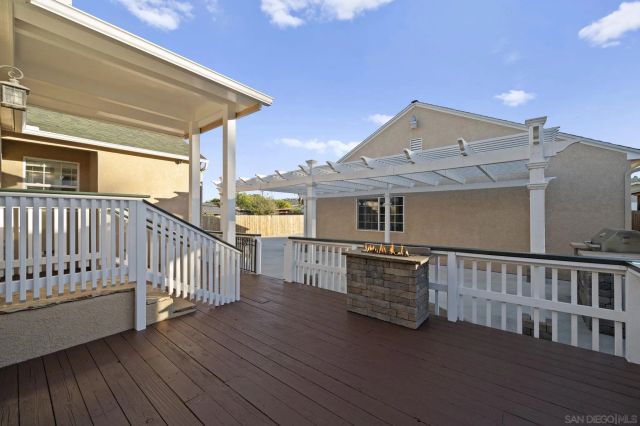 a view of balcony with wooden floor and fence