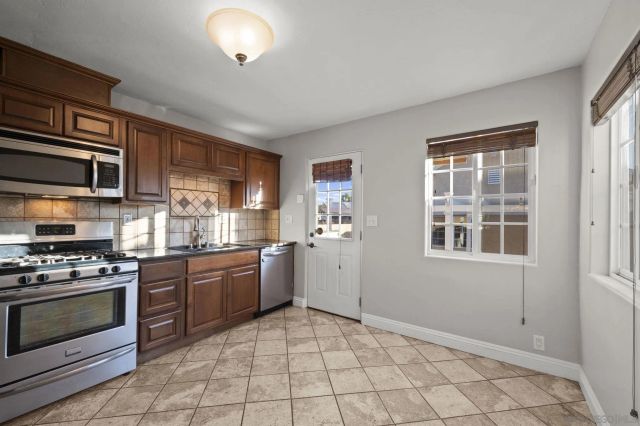 a kitchen with a stove a sink and a microwave