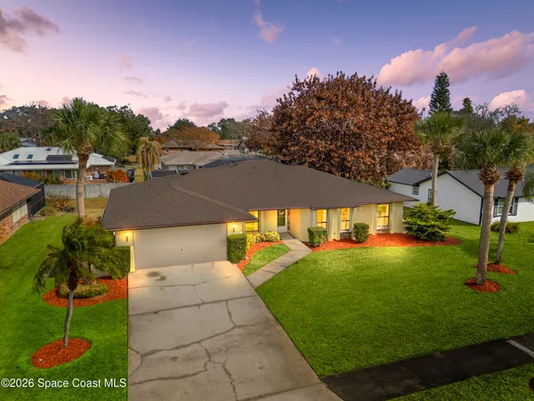 a view of a patio with table and chairs under an umbrella