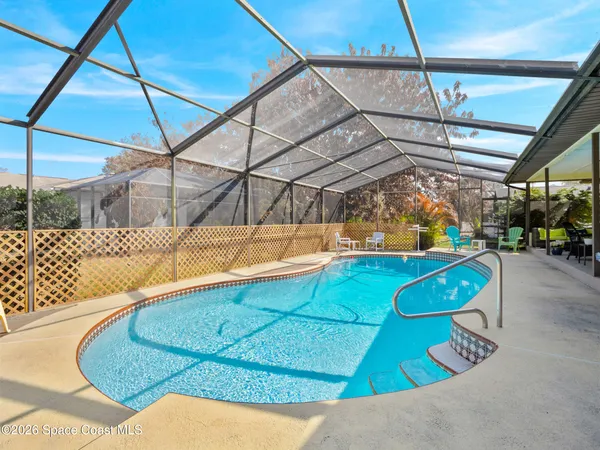 an aerial view of a house with a swimming pool