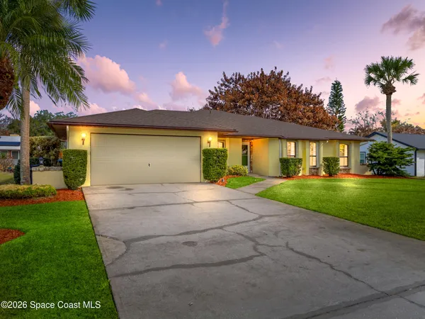 a front view of house with yard and green space