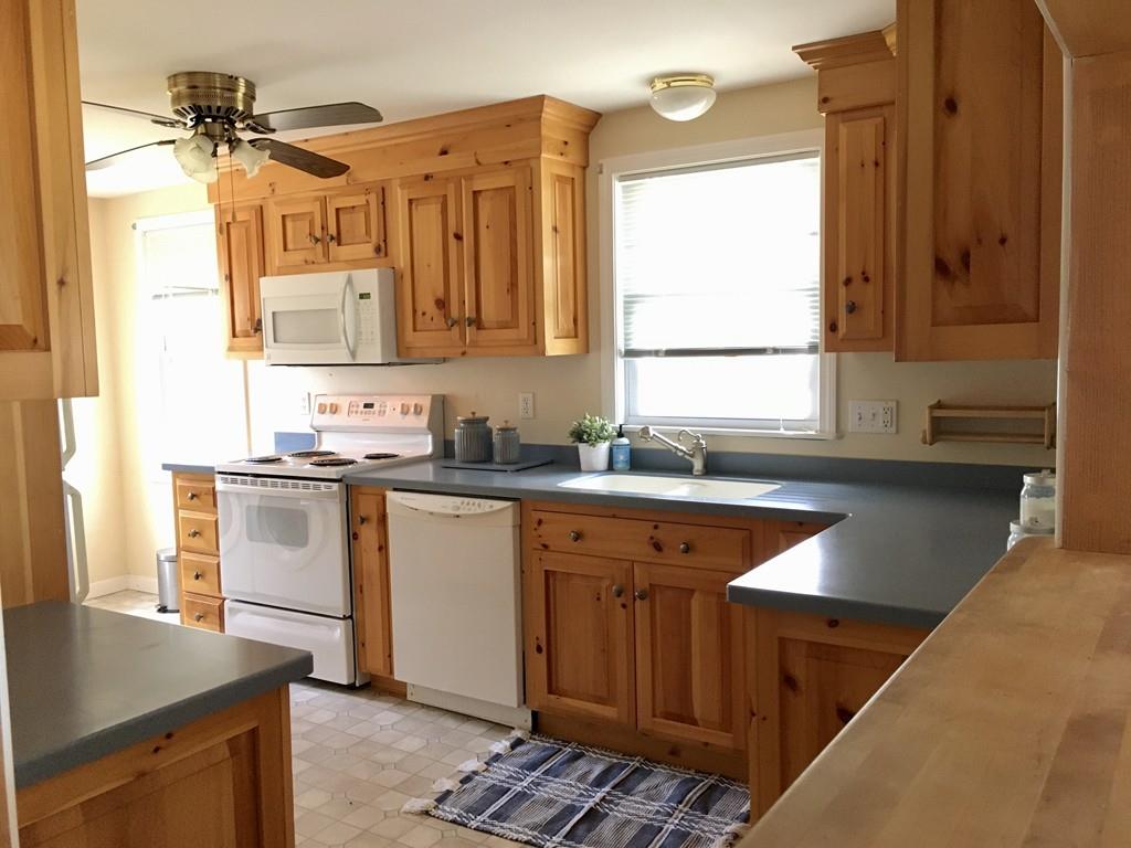 5 Barnacle Road Wareham, MA 02571 - Photo 15 of 28 a kitchen with a sink stove and cabinets