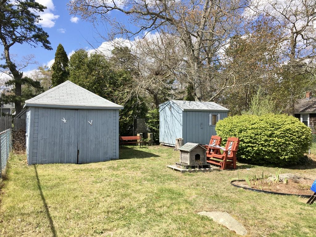 5 Barnacle Road Wareham, MA 02571 - Photo 26 of 28 a view of a backyard with a small cabin