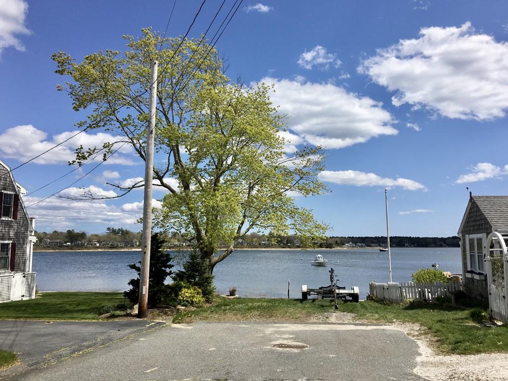 5 Barnacle Road Wareham, MA 02571 - Photo 4 of 28 a backyard of a house with table and chairs