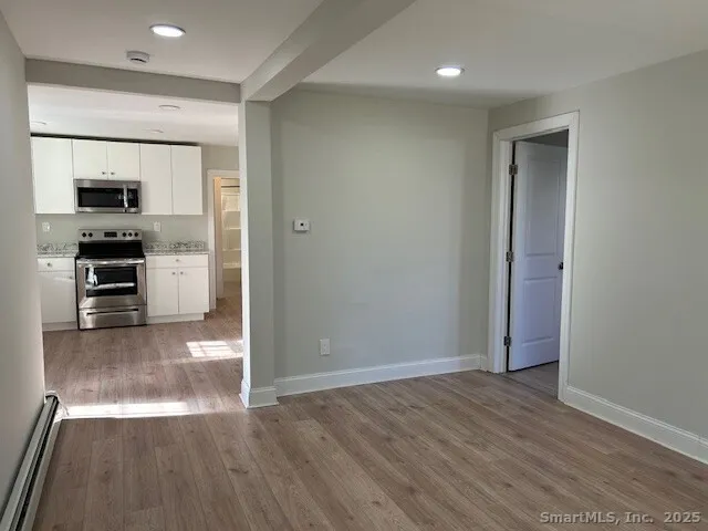 a view of a kitchen with a sink and a refrigerator