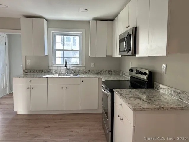 a kitchen with a sink stove and microwave