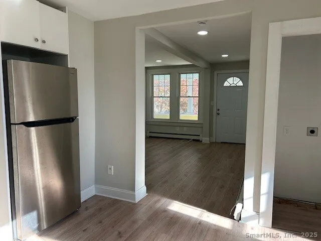 a view of a kitchen with wooden floor and electronic appliances