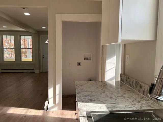 a view of a bathroom with mirror and window