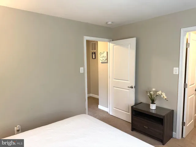 a bedroom with a bed and a dresser