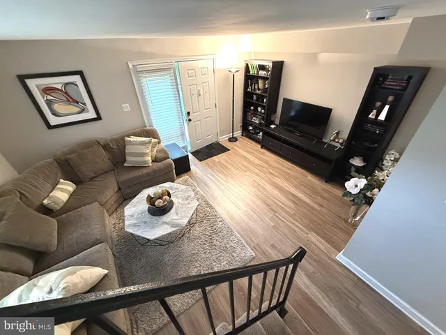 a living room with couches and a flat screen tv