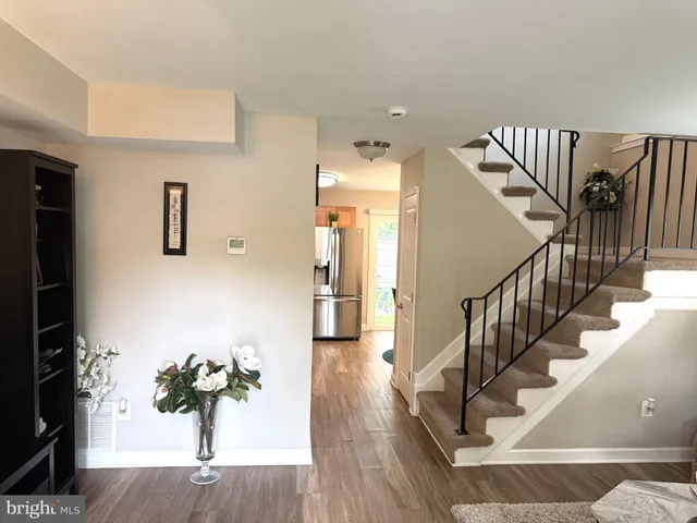 a view of entryway and hall with wooden floor