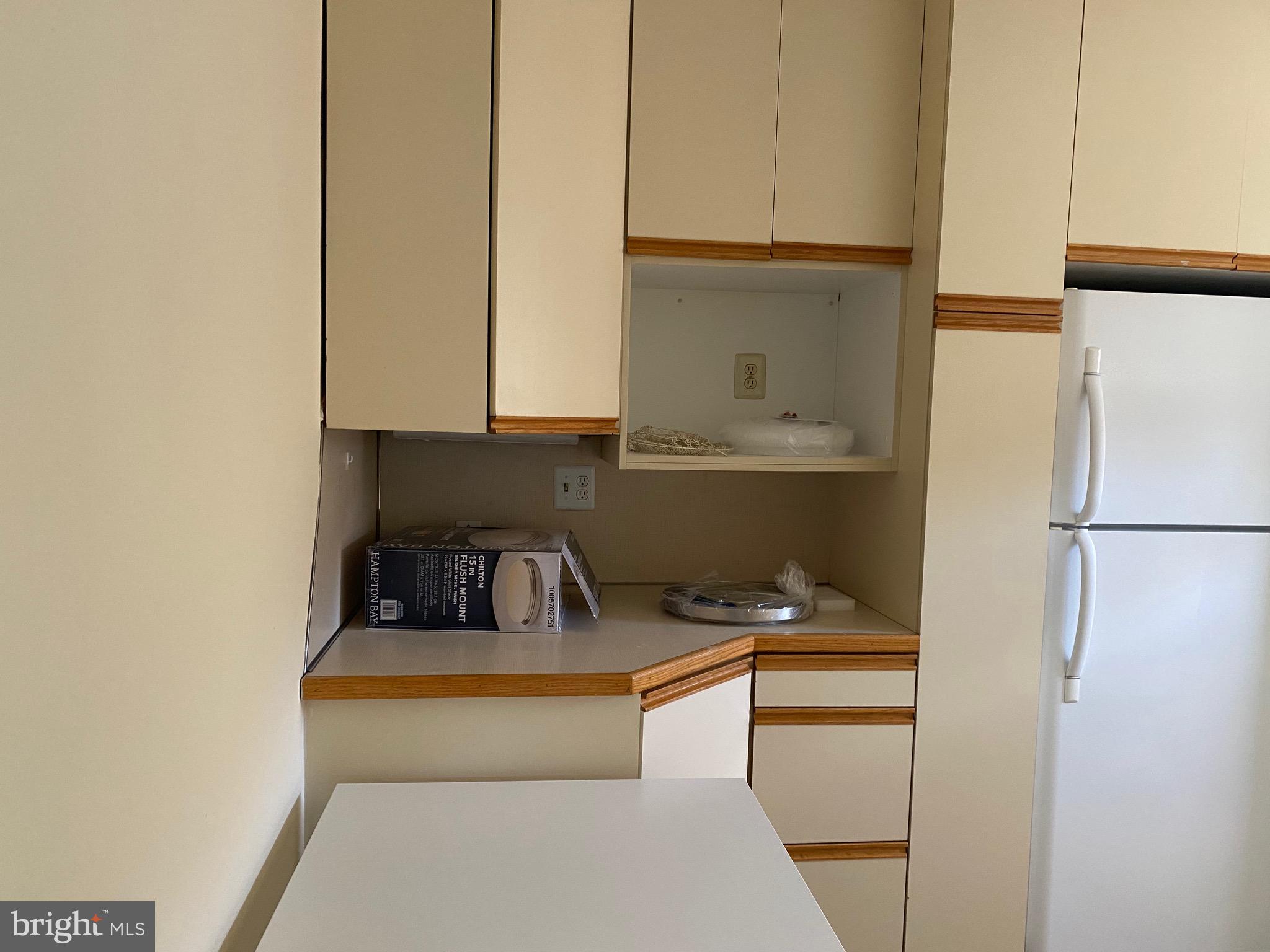 712 Grove Street Haddonfield, NJ 08033 - Photo 16 of 18 a kitchen with a refrigerator and cabinets