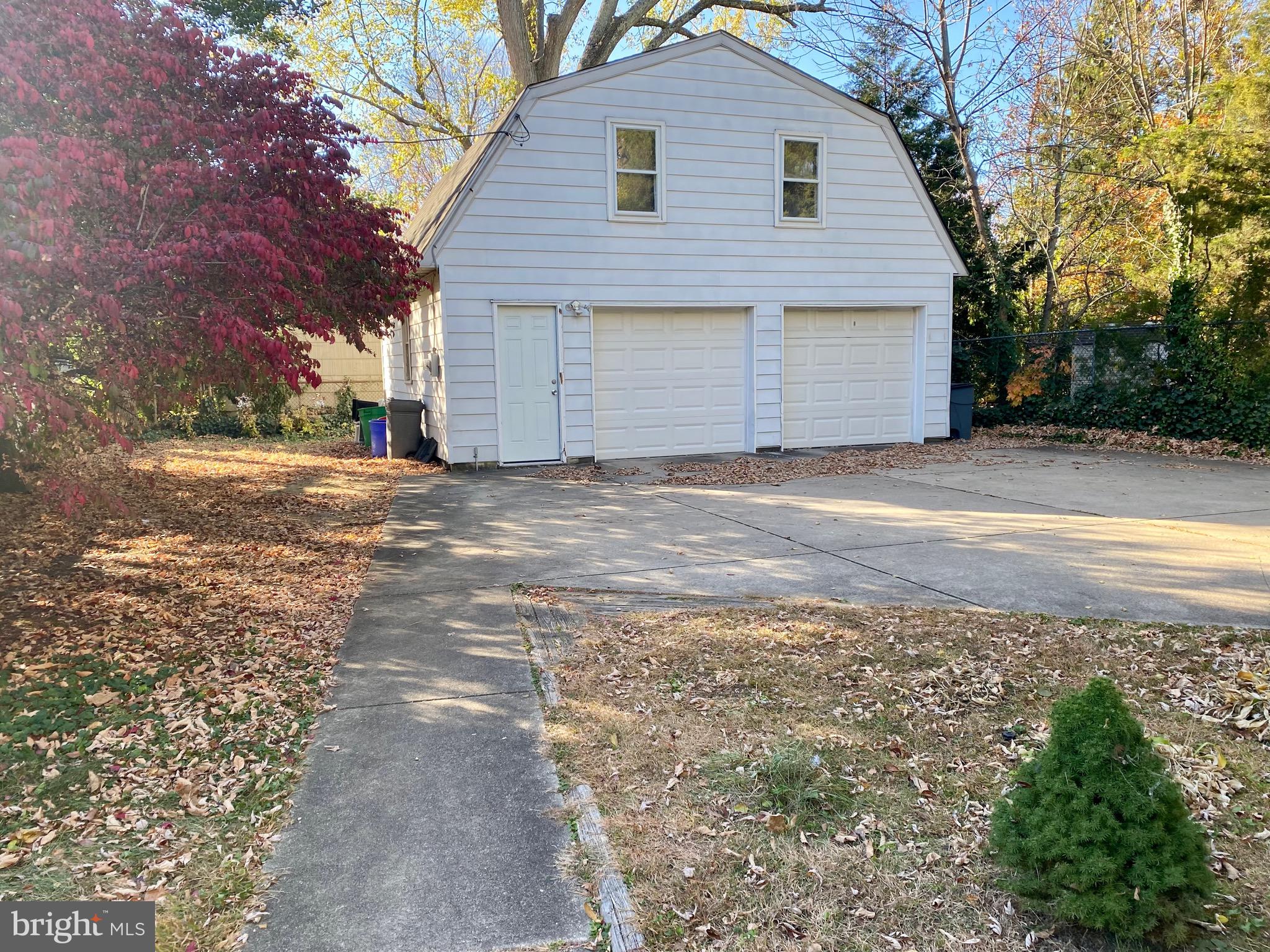 712 Grove Street Haddonfield, NJ 08033 - Photo 8 of 18 a front view of a house with a yard and garage