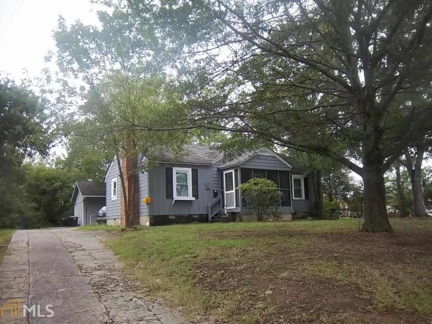a front view of house with yard and trees