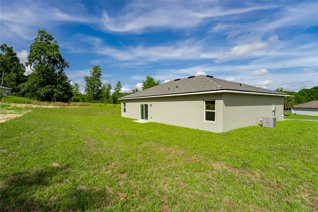 a kitchen with kitchen island granite countertop a stove refrigerator and microwave with wooden floor