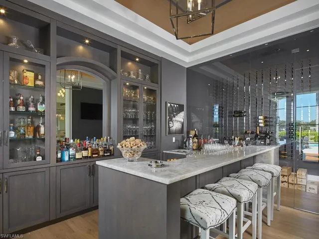 a kitchen with a sink and chairs