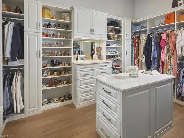 a kitchen with a refrigerator a stove and a bookshelf