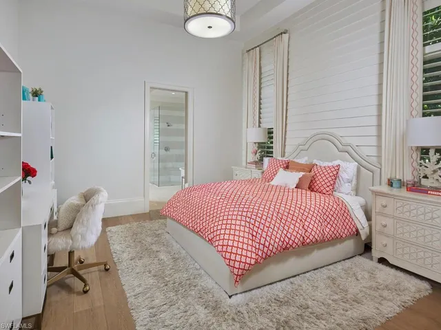 a bedroom with a bed and a chair