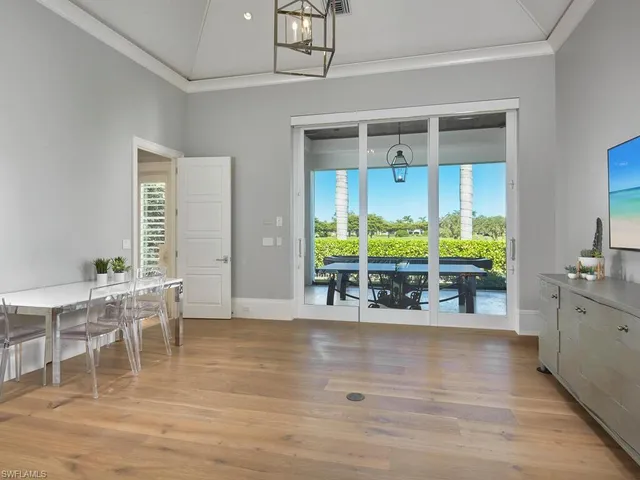 a view of a dining room kitchen with furniture and chandelier