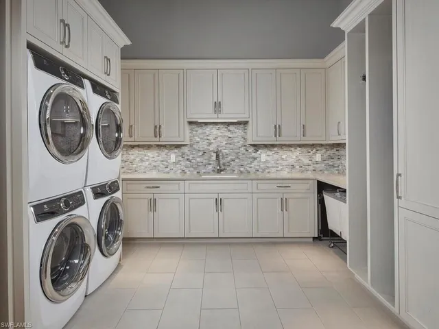 a utility room with sink dryer and washer