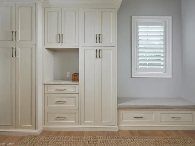 a bathroom with a window and cabinets