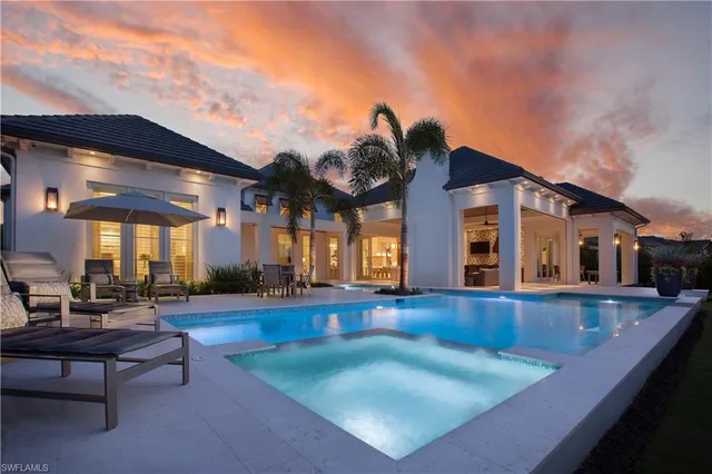 a view of a house with swimming pool and sitting area