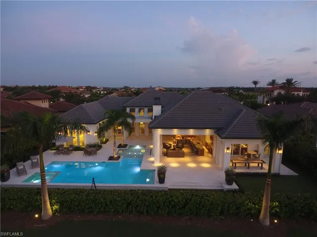 an aerial view of a house with a yard basket ball court and outdoor seating