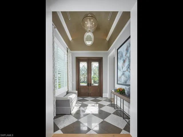 a view of a hallway with wooden floor and a rug
