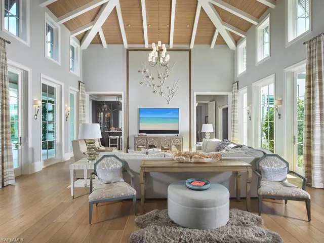 a dining room with furniture a wooden floor and a chandelier