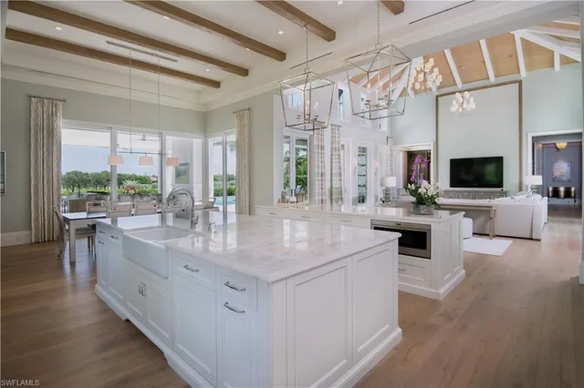 a kitchen with stainless steel appliances granite countertop a sink stove and wooden floor
