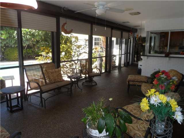 46 Cayuga Road Sea Ranch Lakes, FL 33308 - Photo 19 of 24 a lobby with furniture and floor to ceiling windows