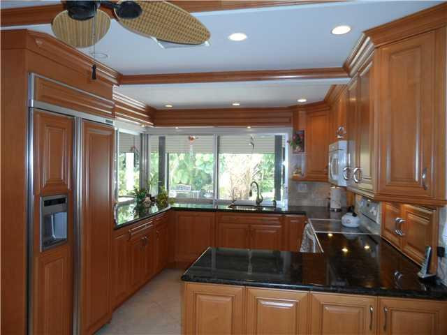 46 Cayuga Road Sea Ranch Lakes, FL 33308 - Photo 5 of 24 a kitchen with stainless steel appliances granite countertop a refrigerator a sink and a stove