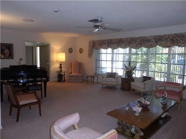 46 Cayuga Road Sea Ranch Lakes, FL 33308 - Photo 8 of 24 a living room with furniture and a large window
