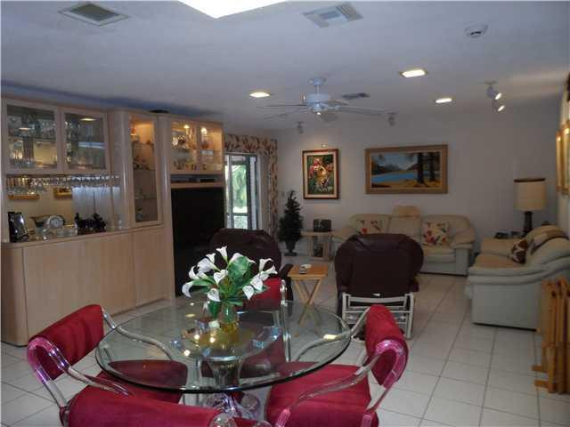 46 Cayuga Road Sea Ranch Lakes, FL 33308 - Photo 9 of 24 a living room with furniture flowerpot and a fireplace